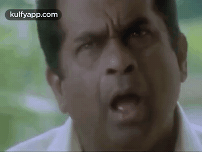 A Close Up Of A Man 'S Face With His Mouth Open And His Eyes Closed . GIF