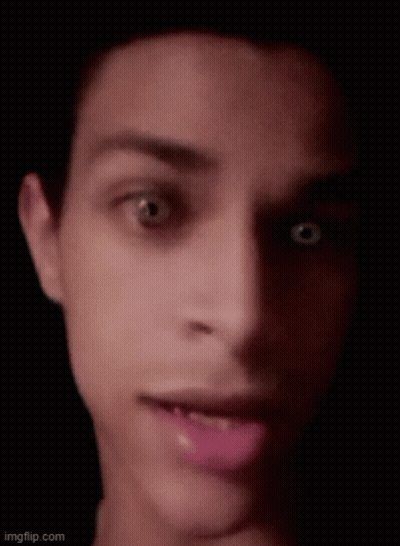 A Close Up Of A Man 'S Face With His Mouth Open And His Eyes Looking At The Camera . GIF
