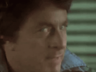 A Close Up Of A Man 'S Face With His Mouth Open And His Eyes Looking At The Camera . GIF