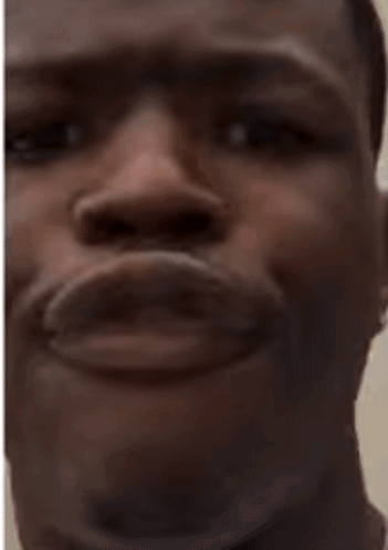 A Close Up Of A Man 'S Face With His Mouth Open And His Eyes Looking At The Camera . GIF