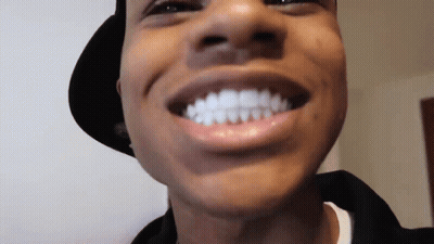 A Close Up Of A Man 'S Face With His Mouth Open And His Teeth Visible . GIF