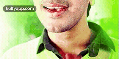 A Close Up Of A Man 'S Face With His Mouth Open And His Tongue Sticking Out . GIF