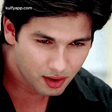 A Close Up Of A Man 'S Face With His Mouth Open And His Tongue Sticking Out . GIF