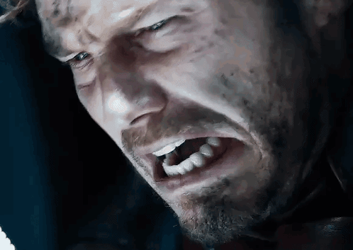 A Close Up Of A Man 'S Face With His Mouth Open And Teeth Showing . GIF