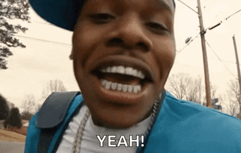 A Close Up Of A Man 'S Face With His Mouth Open And The Words `` Yeah '' . GIF
