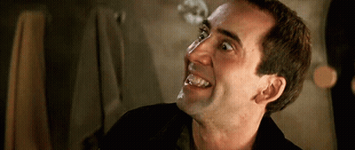A Close Up Of A Man 'S Face With His Mouth Open GIF