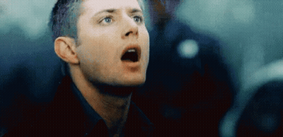 A Close Up Of A Man 'S Face With His Mouth Open Looking Up . GIF