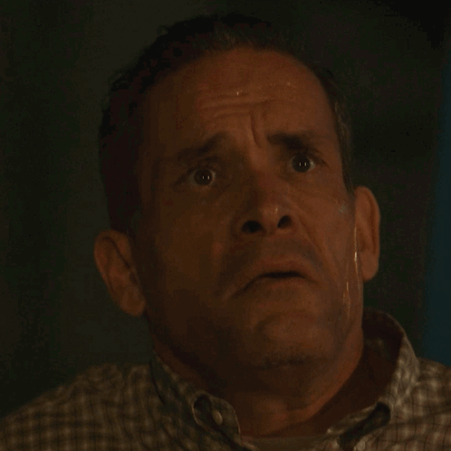A Close Up Of A Man 'S Face With His Mouth Open GIF