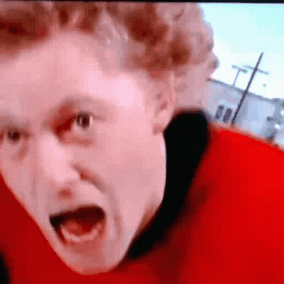 A Close Up Of A Man 'S Face With His Mouth Wide Open GIF