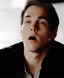 A Close Up Of A Man 'S Face With His Mouth Wide Open GIF