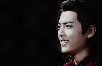 A Close Up Of A Man 'S Face With Long Hair GIF