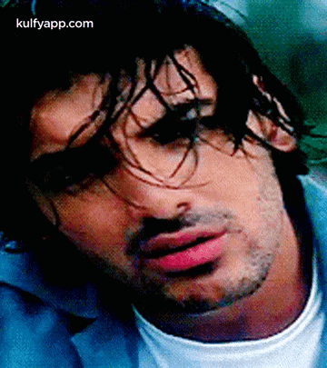 A Close Up Of A Man 'S Face With Long Hair And A Beard . GIF