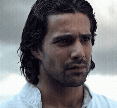 A Close Up Of A Man 'S Face With Long Hair And A Beard . GIF