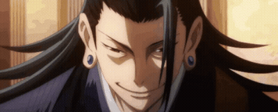 A Close Up Of A Man 'S Face With Long Hair And Blue Earrings GIF