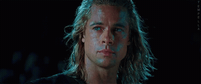 A Close Up Of A Man 'S Face With Long Hair And Blue Eyes . GIF
