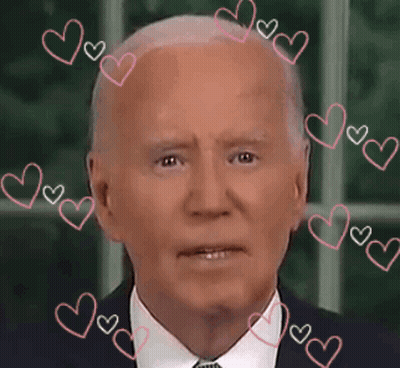 A Close Up Of A Man 'S Face With Pink Hearts Around It GIF