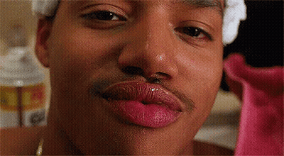 A Close Up Of A Man 'S Face With Pink Lipstick On His Lips . GIF