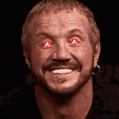 A Close Up Of A Man 'S Face With Red Eyes And A Red Triangle In His Eyes GIF