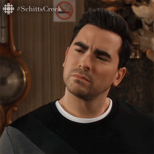 A Close Up Of A Man 'S Face With #Schitts Creek In The Upper Right Corner GIF