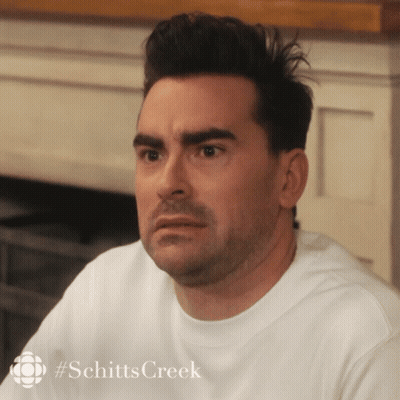 A Close Up Of A Man 'S Face With #Schitts Creek On The Bottom GIF