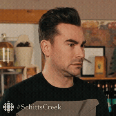 A Close Up Of A Man 'S Face With #Schitts Creek Written On The Bottom Right GIF