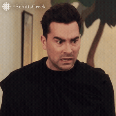 A Close Up Of A Man 'S Face With #Schitts Creek Written On The Bottom Right GIF