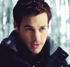 A Close Up Of A Man 'S Face With Snow Falling GIF