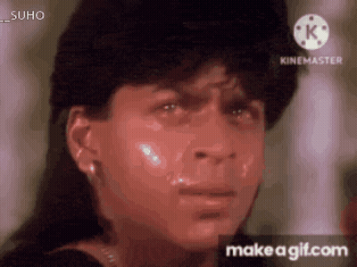 a close up of a man 's face with tears coming out of his eyes