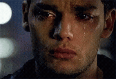 A Close Up Of A Man 'S Face With Tears Coming Out Of His Eyes . GIF