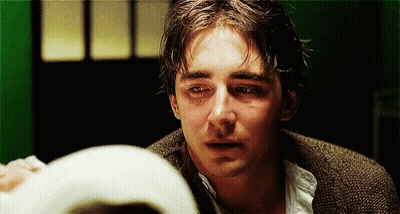 A Close Up Of A Man 'S Face With Tears Coming Out Of His Eyes . GIF