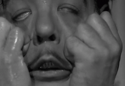 A Close Up Of A Man 'S Face With Tears Running Down His Face . GIF