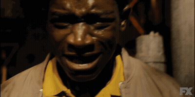 A Close Up Of A Man 'S Face With The Fx Logo In The Background GIF