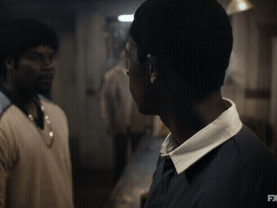 A Close Up Of A Man 'S Face With The Fx Logo In The Background GIF