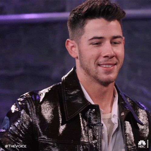A Close Up Of A Man 'S Face With The Hashtag #Thevoice On The Bottom GIF