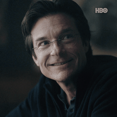 A Close Up Of A Man 'S Face With The Hbo Logo Behind Him GIF