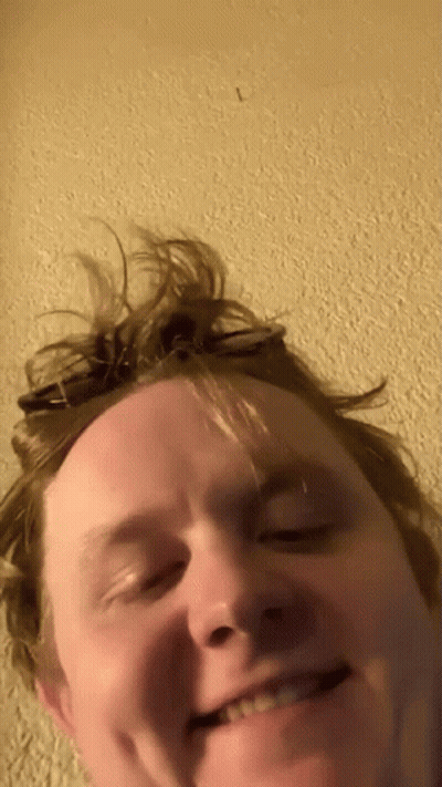 A Close Up Of A Man 'S Face With The Letter L In The Corner GIF