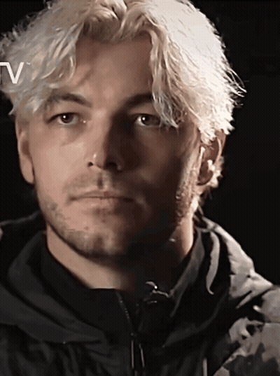 A Close Up Of A Man 'S Face With The Letter V Above Him GIF