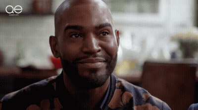 A Close Up Of A Man 'S Face With The Letters Oe Behind Him GIF