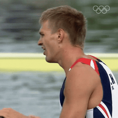 A Close Up Of A Man 'S Face With The Olympic Rings Visible GIF