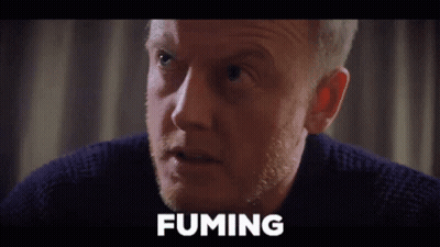 A Close Up Of A Man 'S Face With The Word Fuming Written Above Him GIF