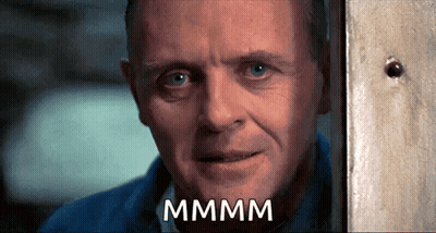 A Close Up Of A Man 'S Face With The Word Mmmm Written On It GIF