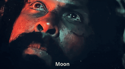 A Close Up Of A Man 'S Face With The Word Moon On The Bottom Right GIF