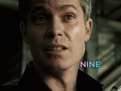 A Close Up Of A Man 'S Face With The Word Nine In Blue Letters GIF