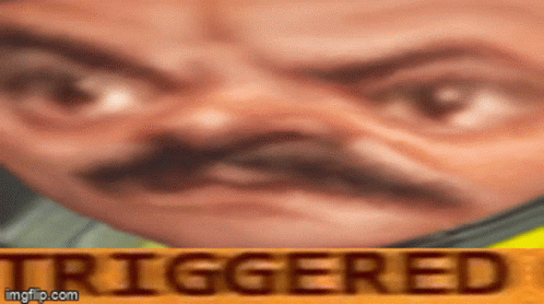 A Close Up Of A Man 'S Face With The Word Triggered In The Corner . GIF