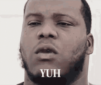 A Close Up Of A Man 'S Face With The Word Yuh Written On It GIF