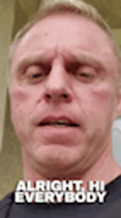 A Close Up Of A Man 'S Face With The Words `` Alright , Hi Everybody '' . GIF