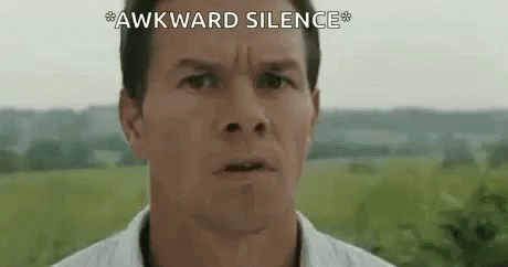 A Close Up Of A Man 'S Face With The Words `` Awkward Silence '' Written On The Bottom . GIF