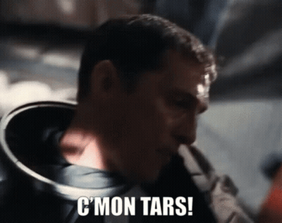 A Close Up Of A Man 'S Face With The Words C ' Mon Tars Written On It . GIF