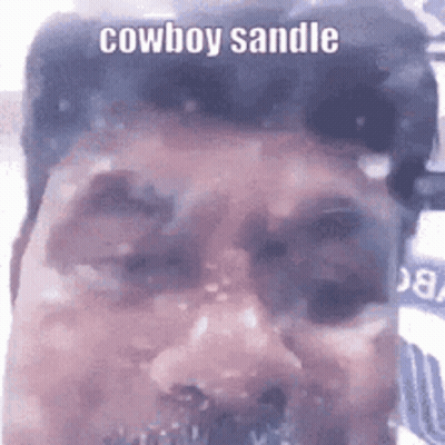 A Close Up Of A Man 'S Face With The Words Cowboy Sandle Written On It . GIF