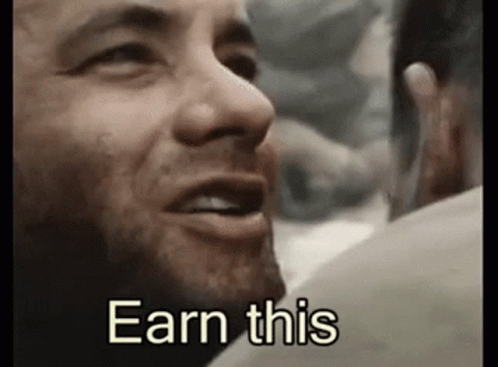 A Close Up Of A Man 'S Face With The Words `` Earn This '' Written Next To Him . GIF